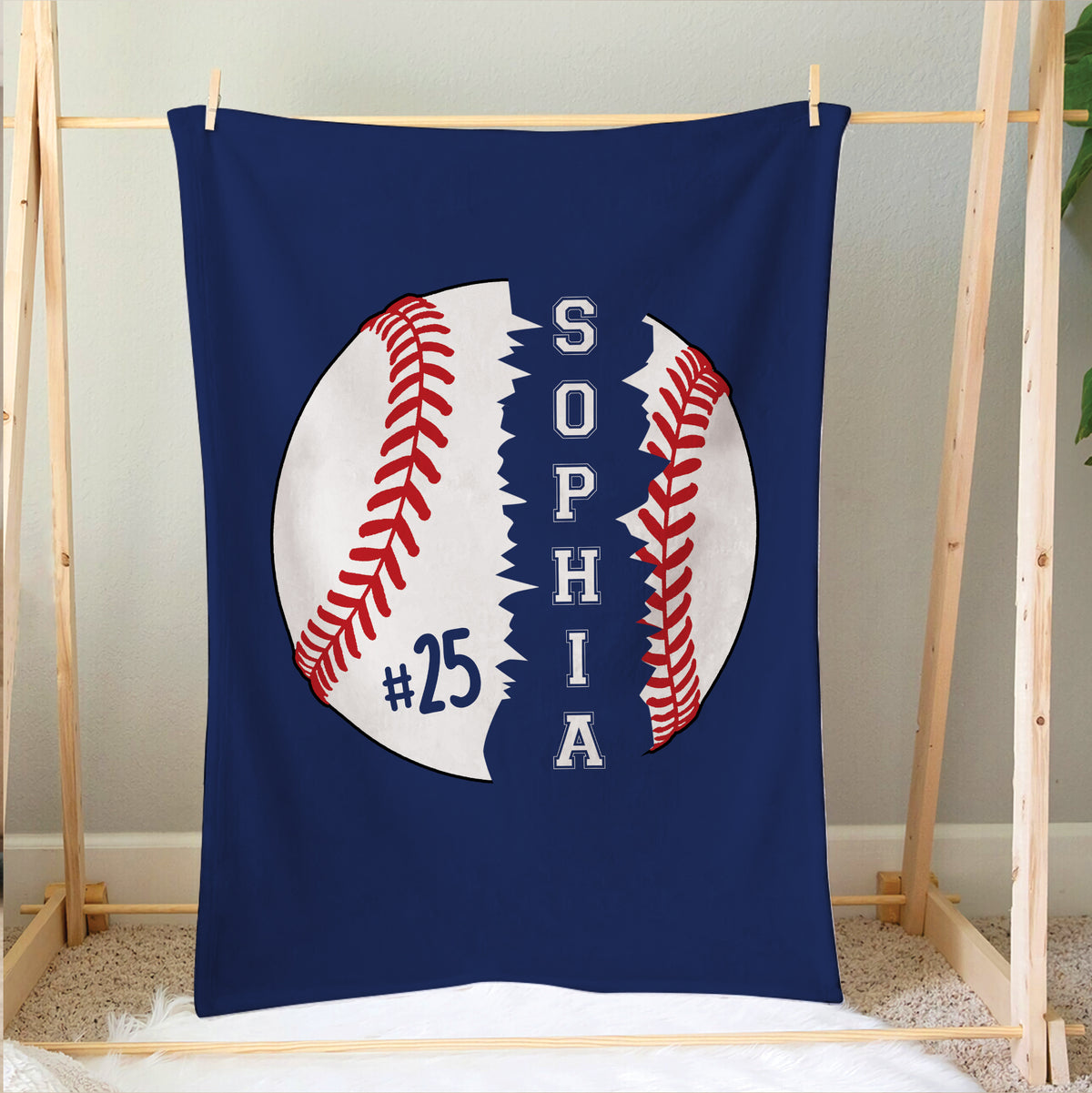 Baseball blanket hanging on a wooden frame with bold navy, white and red sports artwork