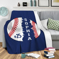 Baseball throw blanket draped over a gray sofa in a cozy living room setting