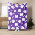 Purple softball throw blanket featuring a repeating white ball pattern in a living room setting