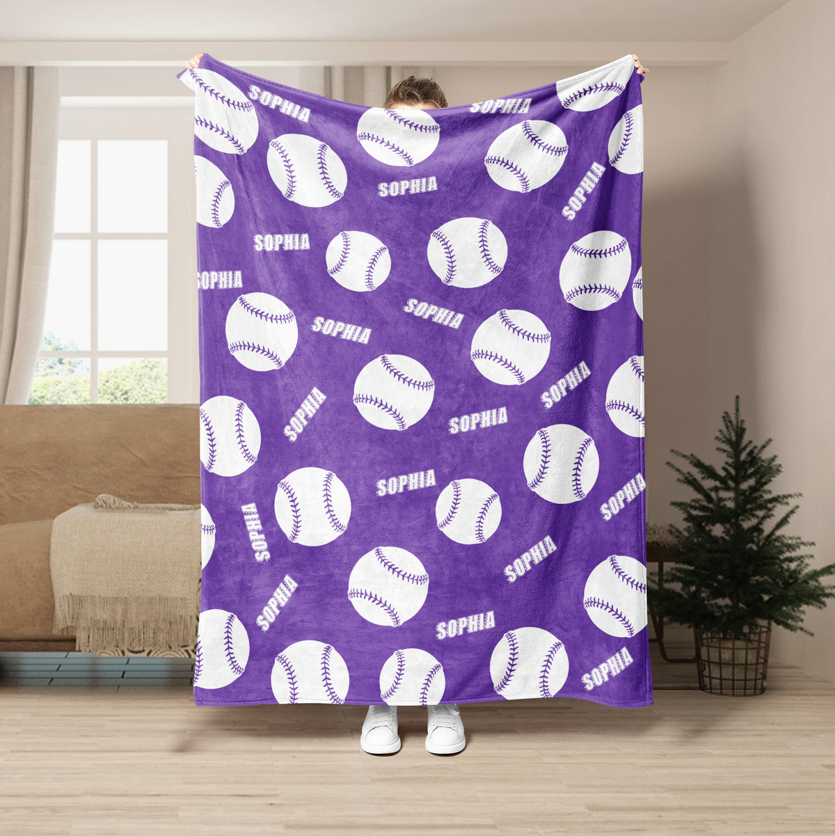 Purple softball throw blanket featuring a repeating white ball pattern in a living room setting