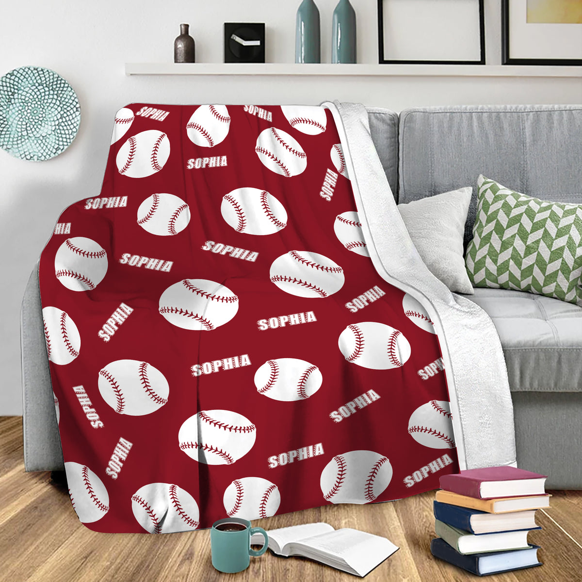 Red softball blanket draped over a sofa with repeating white ball artwork
