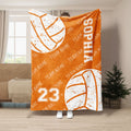 Orange volleyball throw blanket with white distressed volleyball artwork and bold athletic design