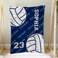 Blue volleyball blanket displayed on a bed with large volleyball graphics and sports-inspired artwork