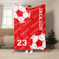 Red soccer throw blanket featuring large distressed soccer balls and bold team sports graphics