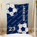 Navy soccer blanket hanging in a bedroom with distressed soccer balls and coordinated team artwork