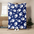 Navy football blanket displayed with repeating white football illustrations in a living room setting