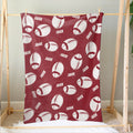Red football blanket hanging on a wooden display frame with repeating football artwork