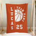 Orange basketball blanket hung on a wooden frame with bold white sports artwork