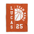 Orange basketball blanket shown flat with a large white basketball and varsity-style design