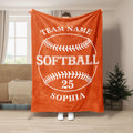 Orange softball throw blanket displayed in a room with bold white softball artwork