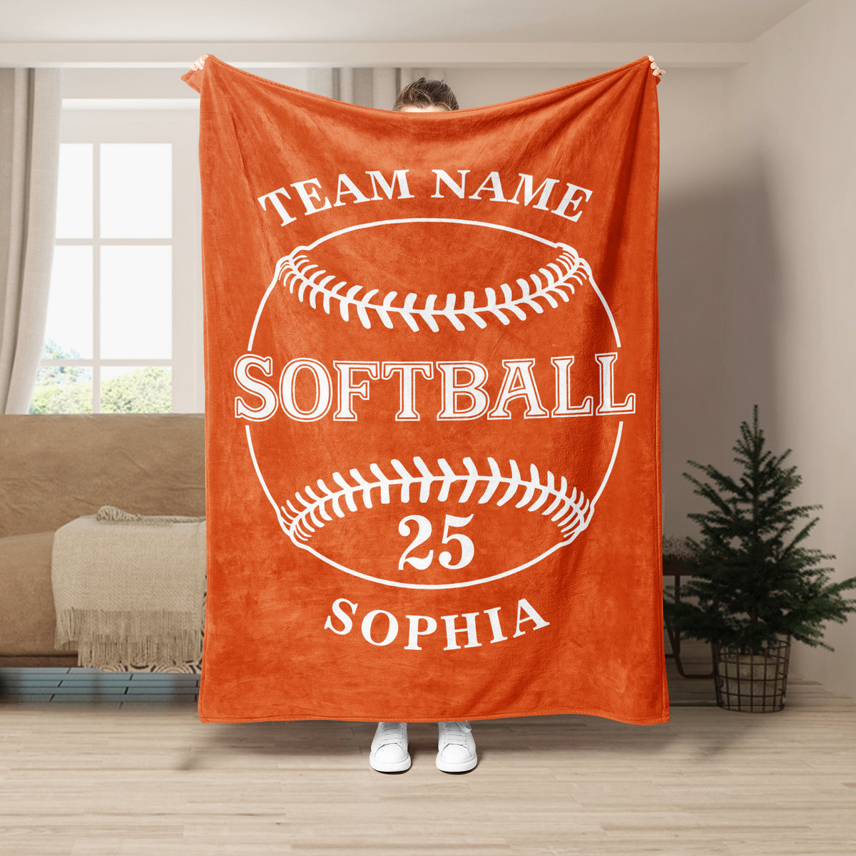 Orange softball throw blanket displayed in a room with bold white softball artwork