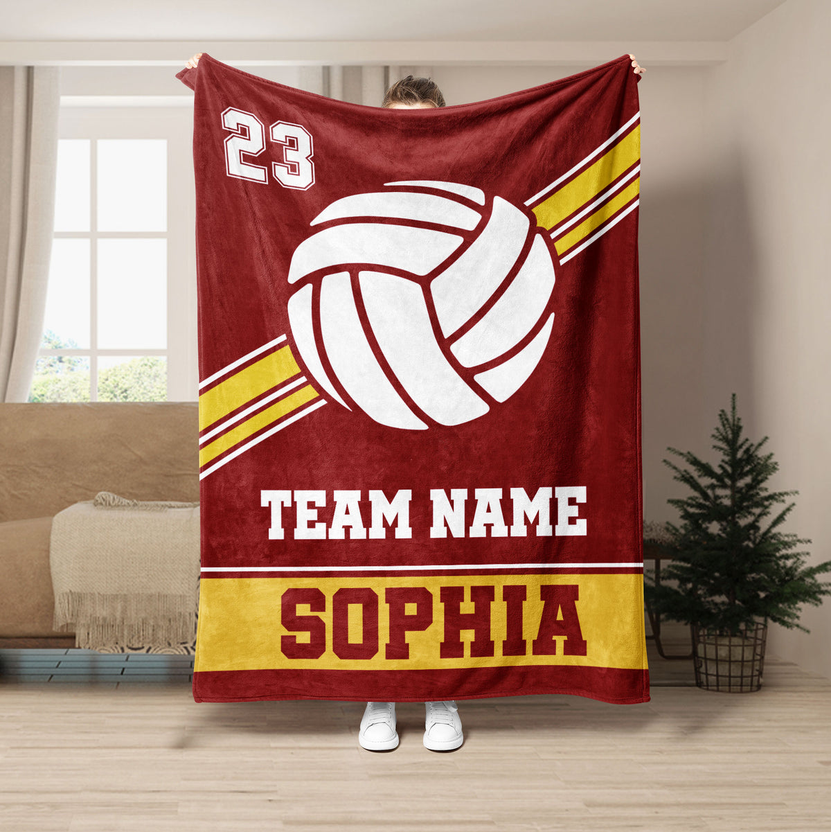 Maroon volleyball throw blanket featuring bold white volleyball artwork and gold athletic stripes
