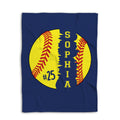 Flat-lay view of a navy softball blanket with a large yellow softball design