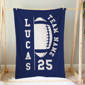 Football blanket hanging on a wooden frame, featuring navy and white sports artwork