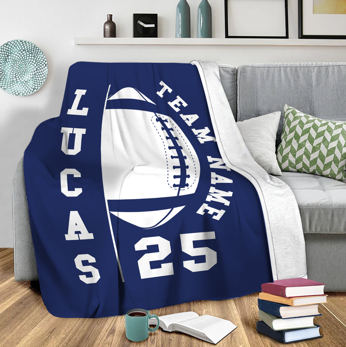 Navy football throw blanket draped over a sofa in a living room setting