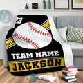 Baseball throw blanket draped over a sofa with bold black, white, and yellow sports artwork