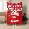 Red basketball throw blanket displayed with bold white basketball artwork in a living room