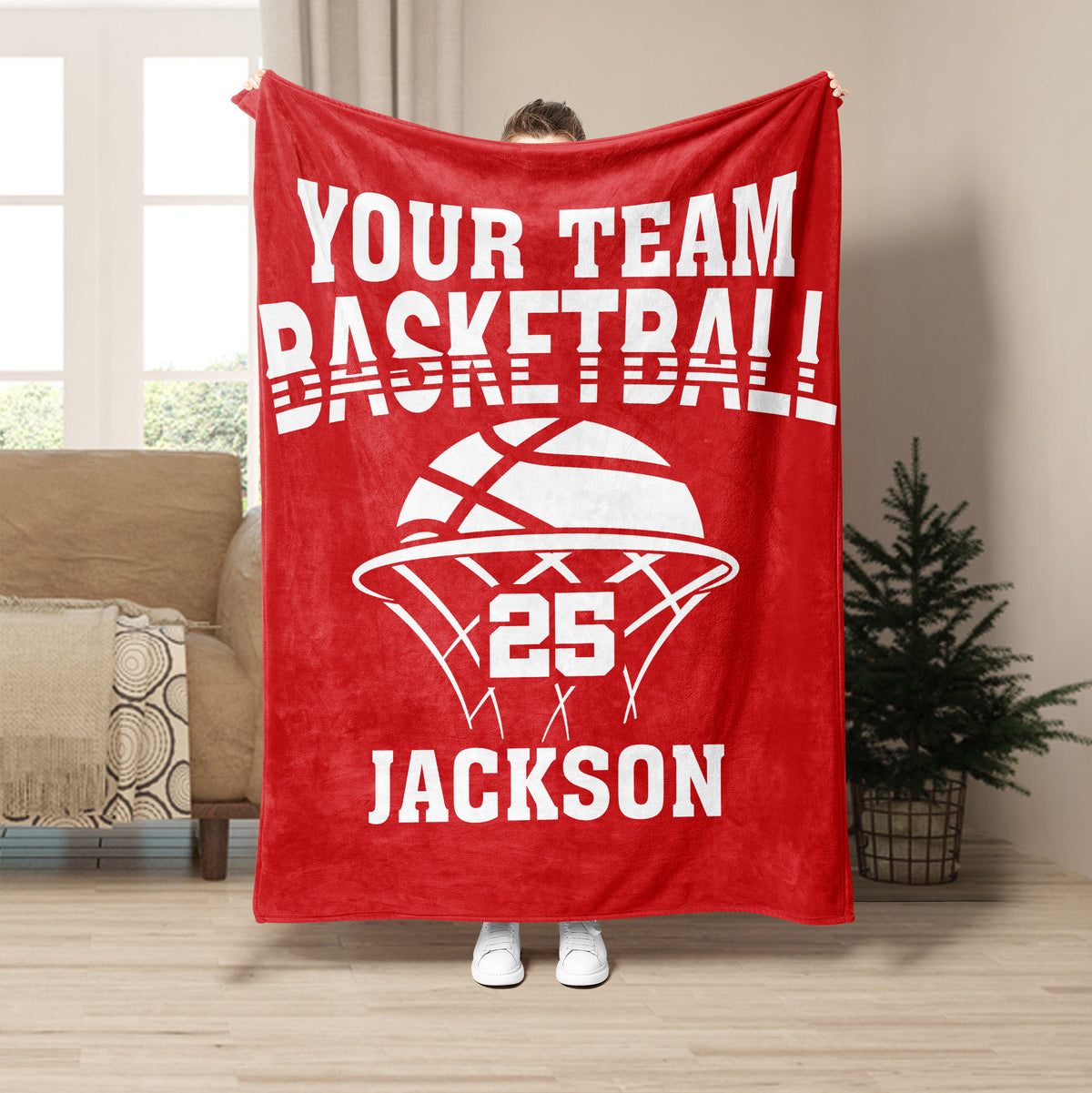 Red basketball throw blanket displayed with bold white basketball artwork in a living room