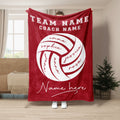 Red volleyball throw blanket shown in a bright living room with bold team sports artwork