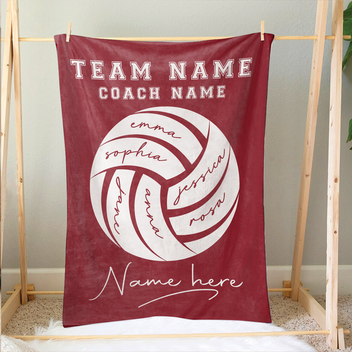 Red volleyball blanket displayed on a wooden frame with large ball artwork and team design