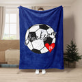 Blue soccer throw blanket displayed in a living room with bold black and white soccer ball artwork