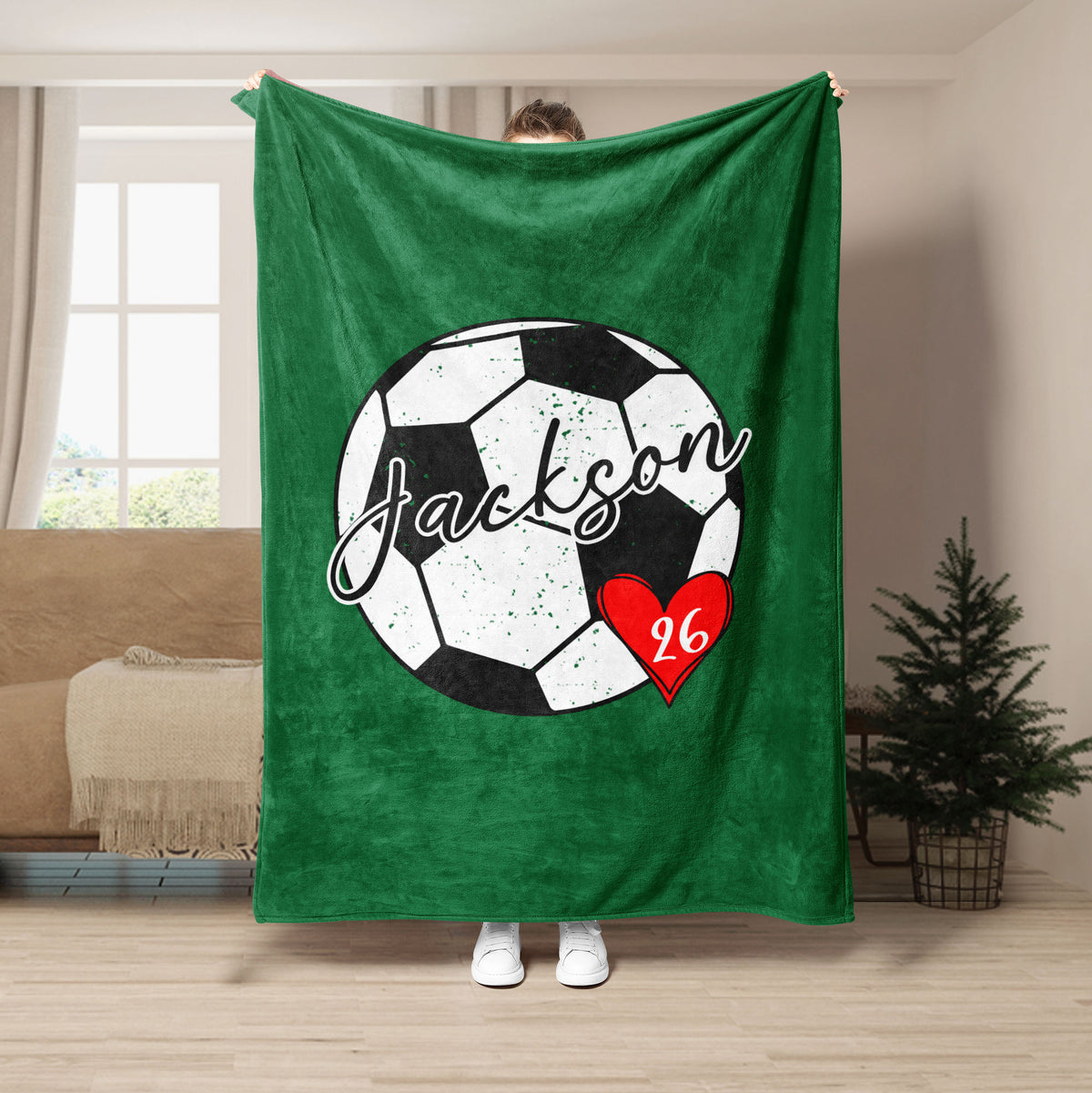 Green soccer throw blanket featuring a bold soccer ball graphic and red heart accent