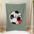 Soccer blanket draped on a bedroom frame with a large black and white soccer ball design