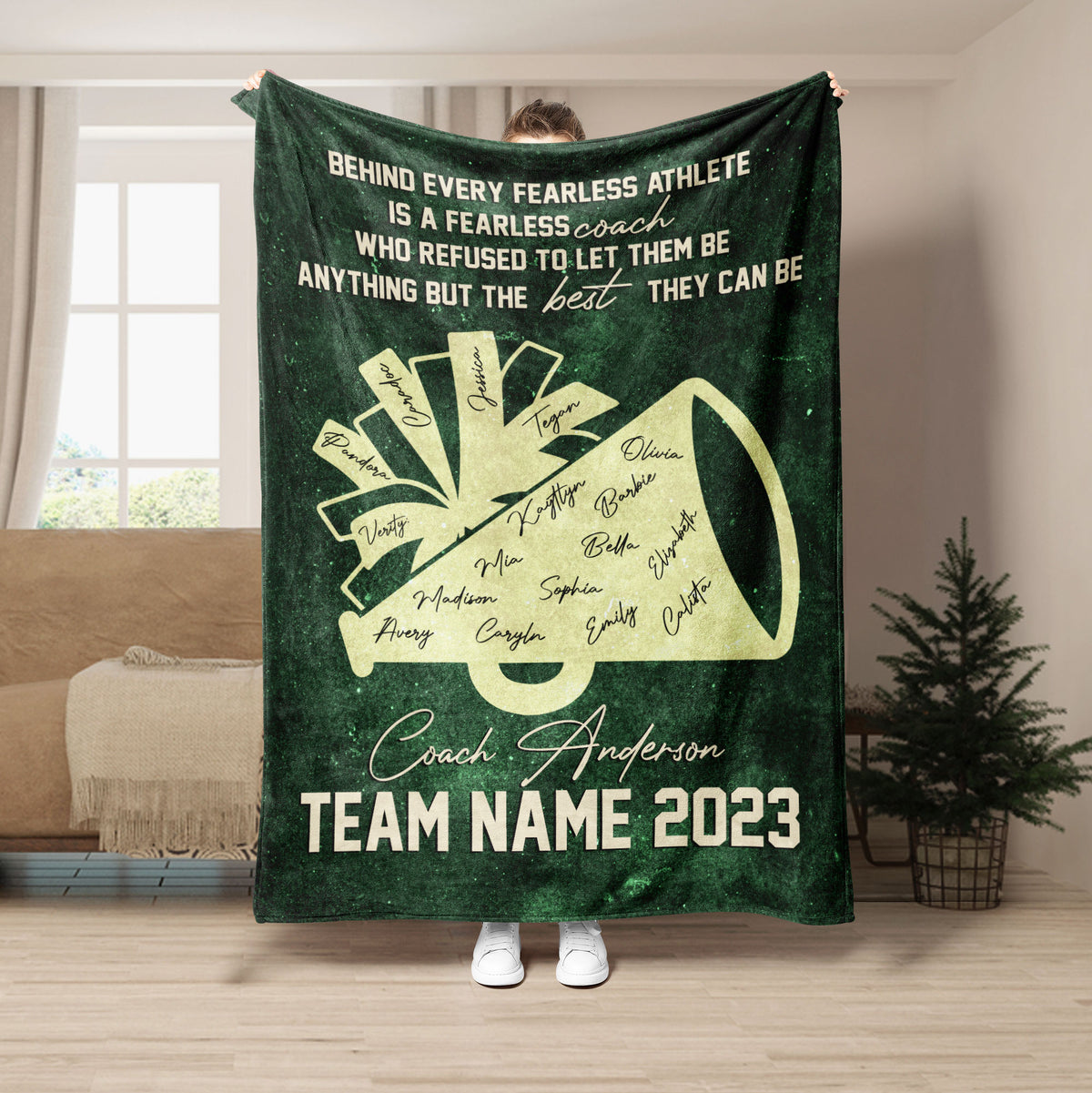 Green cheerleading blanket with gold megaphone design and team coach tribute artwork