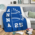 Blue softball throw blanket draped over a sofa in a cozy living room setting