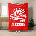 Red basketball throw blanket displayed in a living room with bold white basketball artwork