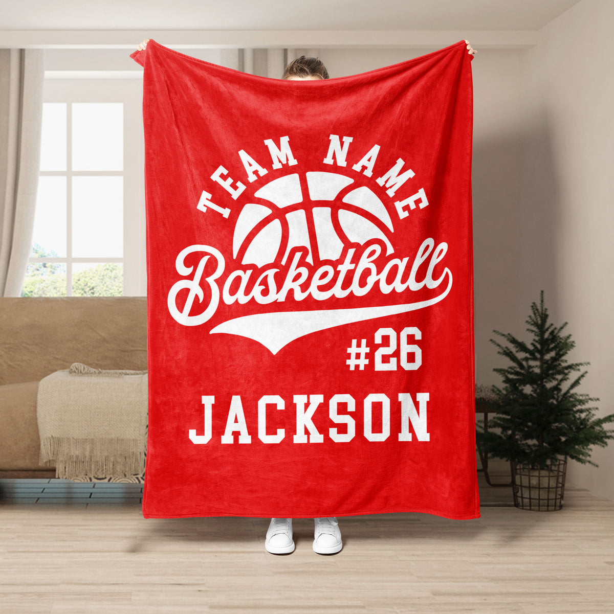 Red basketball throw blanket displayed in a living room with bold white basketball artwork