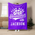 Purple basketball throw blanket displayed in a living room with bold white basketball artwork