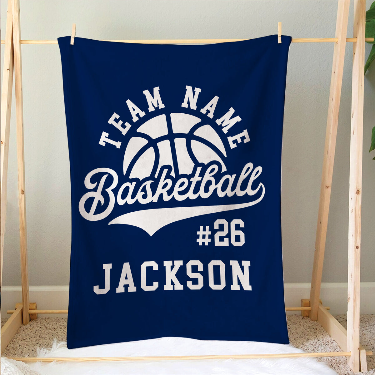 Navy basketball blanket hanging on a wooden display frame with bold white sports artwork