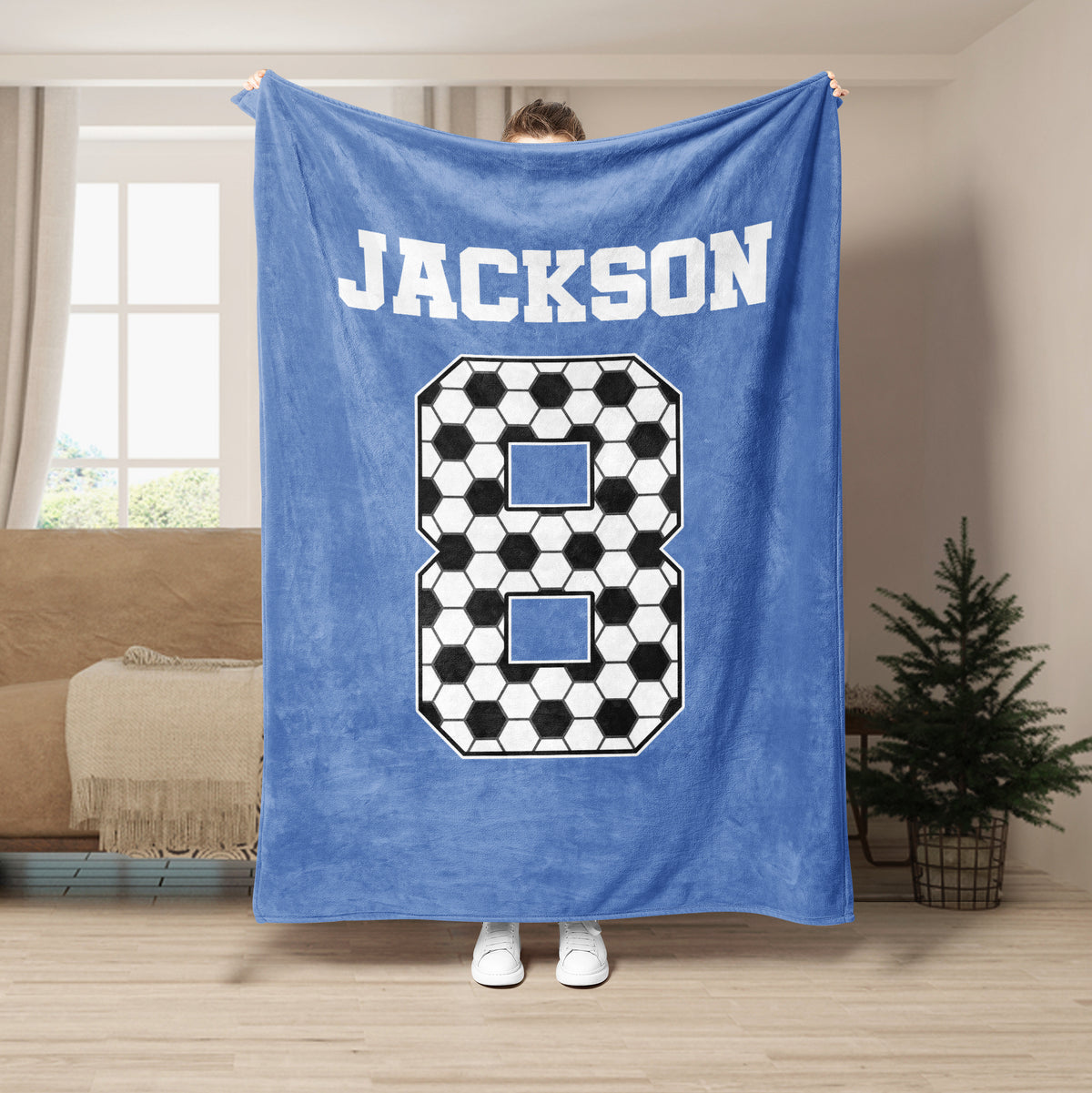 Light blue soccer blanket featuring a large black and white ball-pattern numeral design