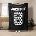 Black soccer throw blanket with bold white soccer ball pattern and sports-inspired artwork
