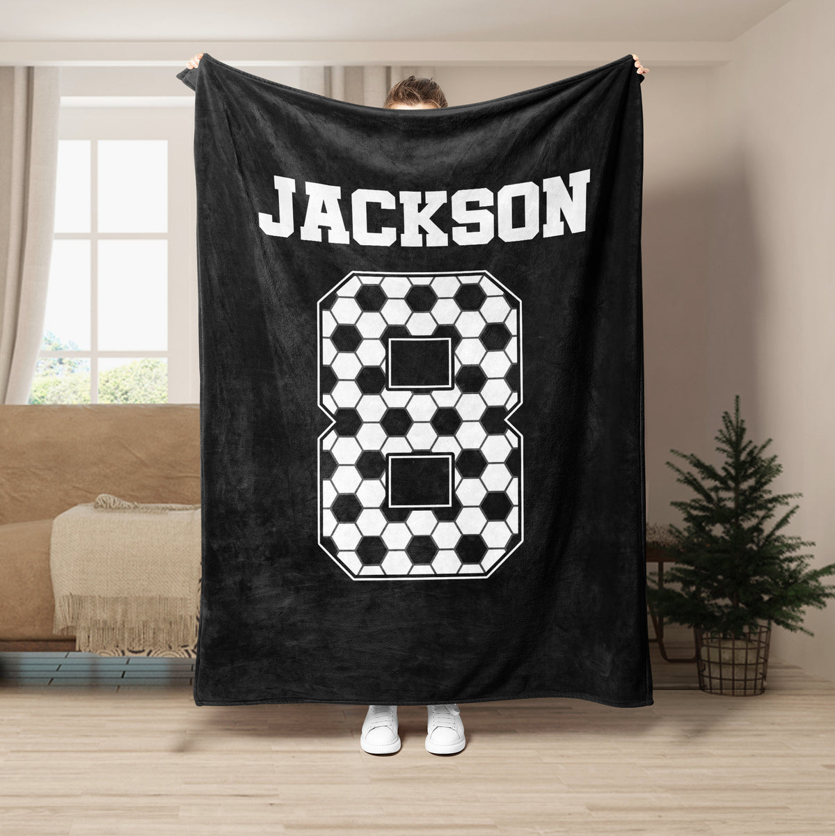 Black soccer throw blanket with bold white soccer ball pattern and sports-inspired artwork