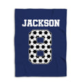 Navy soccer blanket laid flat with large black and white soccer ball artwork