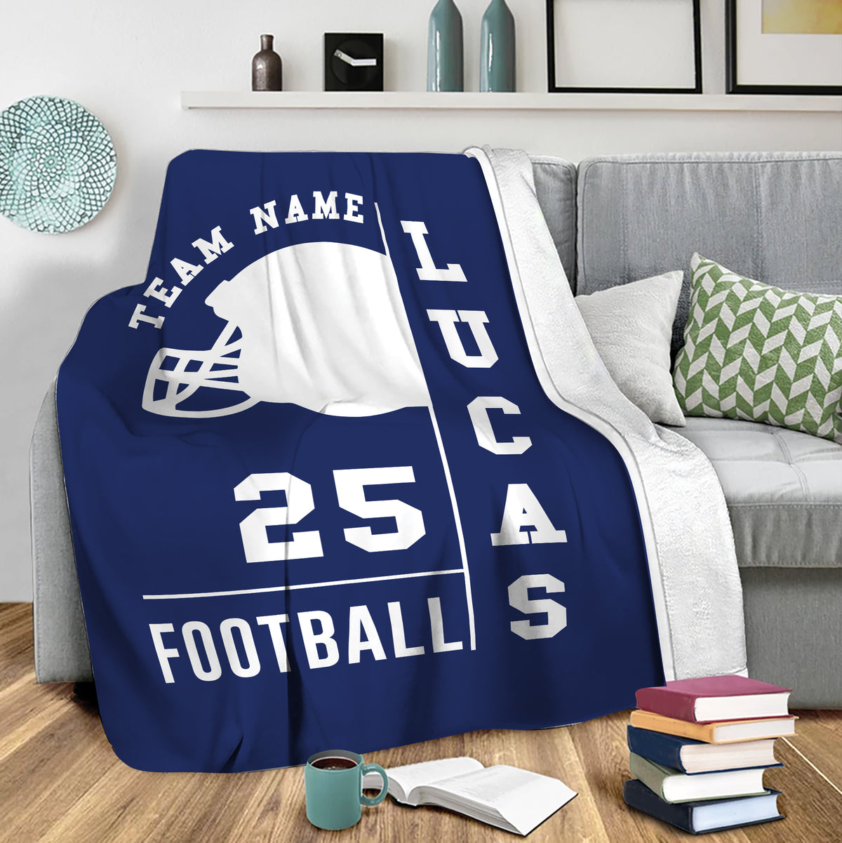 Football throw blanket draped over a sofa, showcasing a navy helmet design in a cozy living room