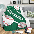 Green baseball blanket draped over a sofa with oversized baseballs and bold white stripe details