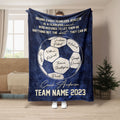 Navy soccer coach throw blanket displayed in a living room with soccer ball artwork