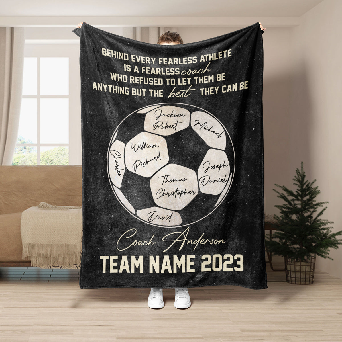 Black soccer coach blanket featuring a soccer ball design and inspirational team message
