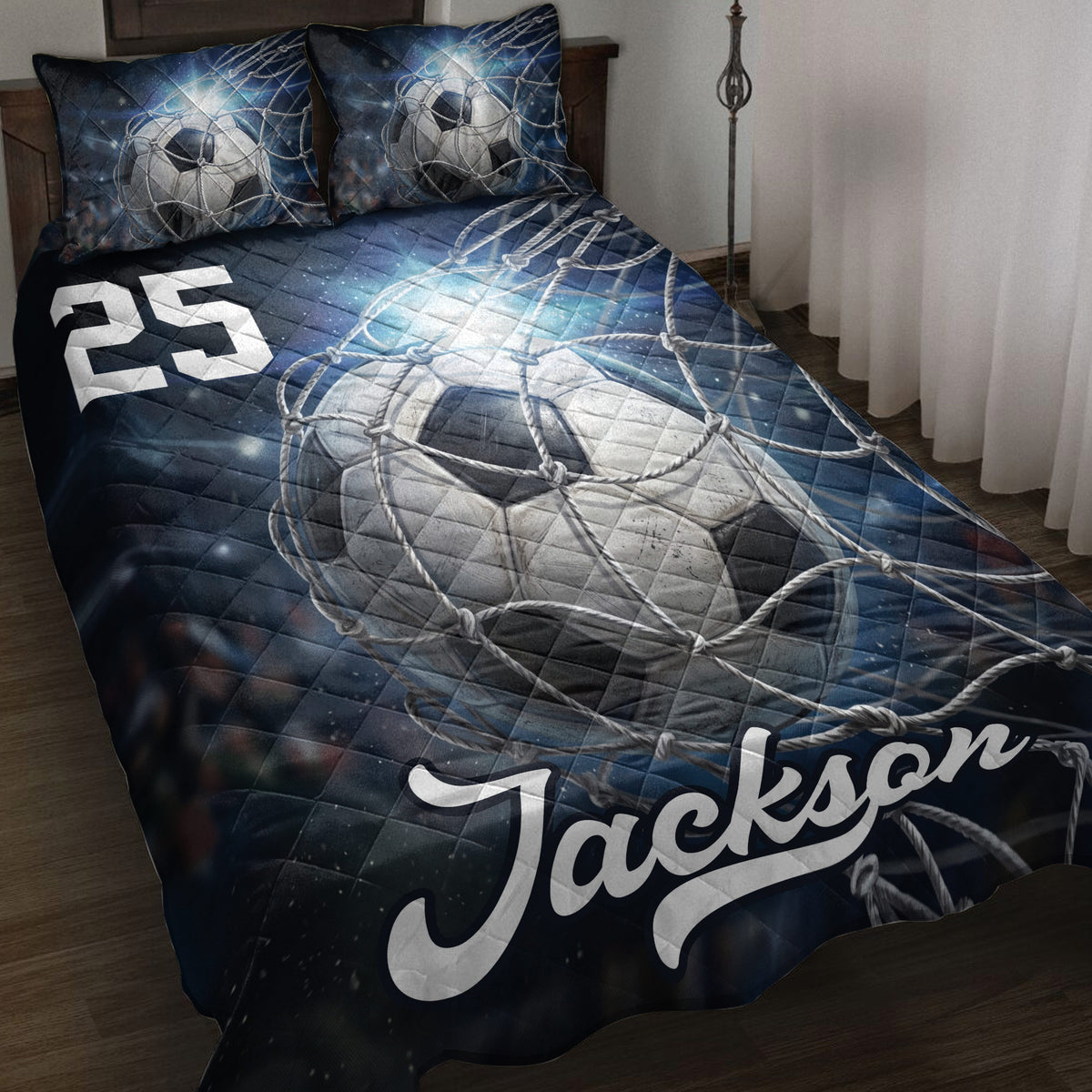 Soccer quilt blanket displayed on a bed with dark blue cosmic artwork, soccer balls, and goal net details