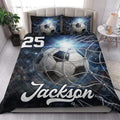 Soccer quilt bedding styled in a bright bedroom with dramatic ball and goal net artwork