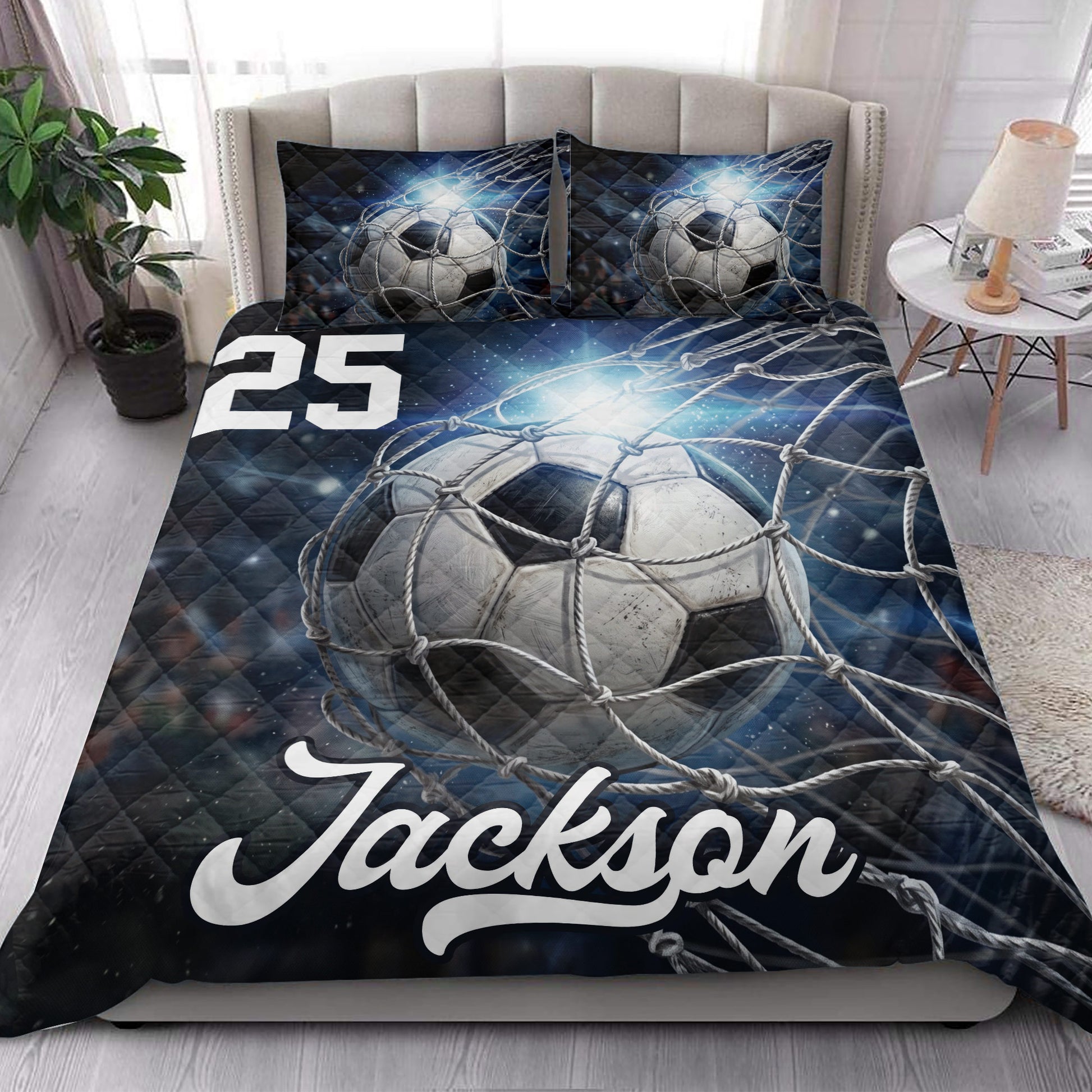 Soccer quilt bedding styled in a bright bedroom with dramatic ball and goal net artwork