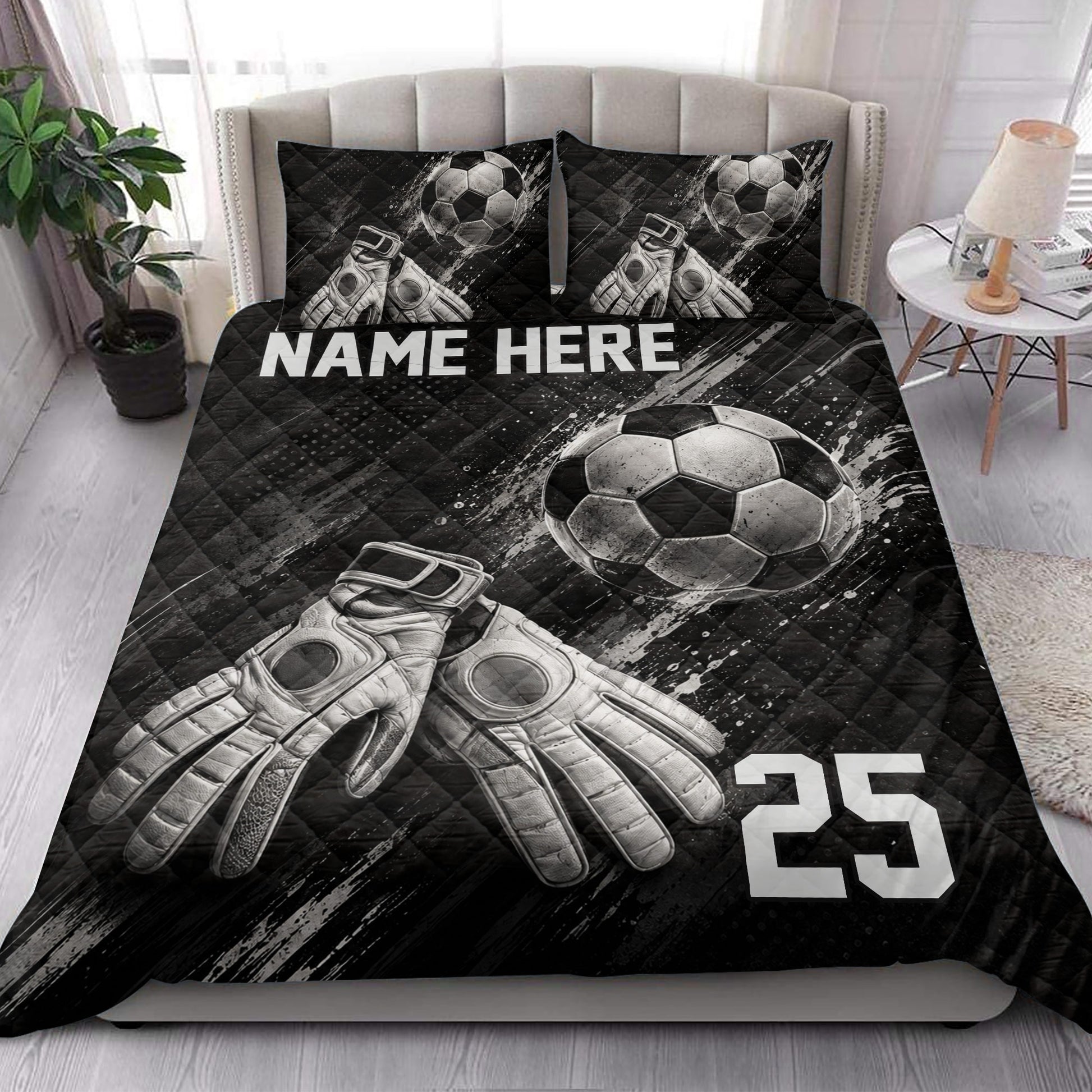 Black soccer quilt blanket styled in a bedroom with soccer ball and goalkeeper glove artwork