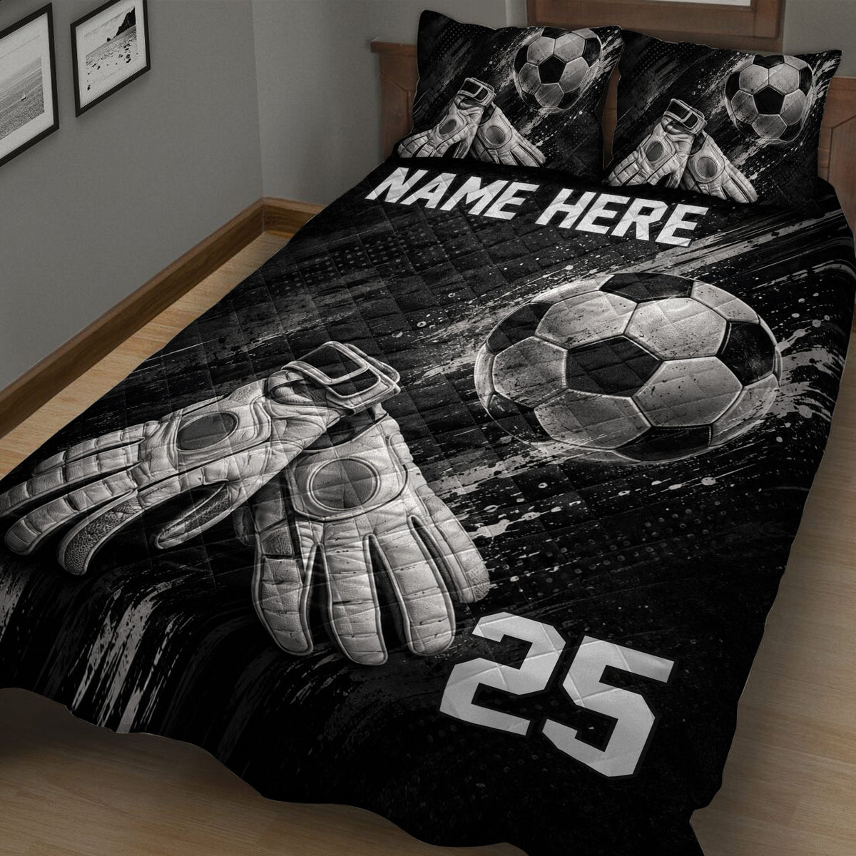 Close bedroom view of a black soccer quilt featuring a soccer ball and goalkeeper gloves