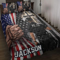 Police quilt blanket displayed on a bed with American flag stripes, stars, crosses, and law enforcement artwork