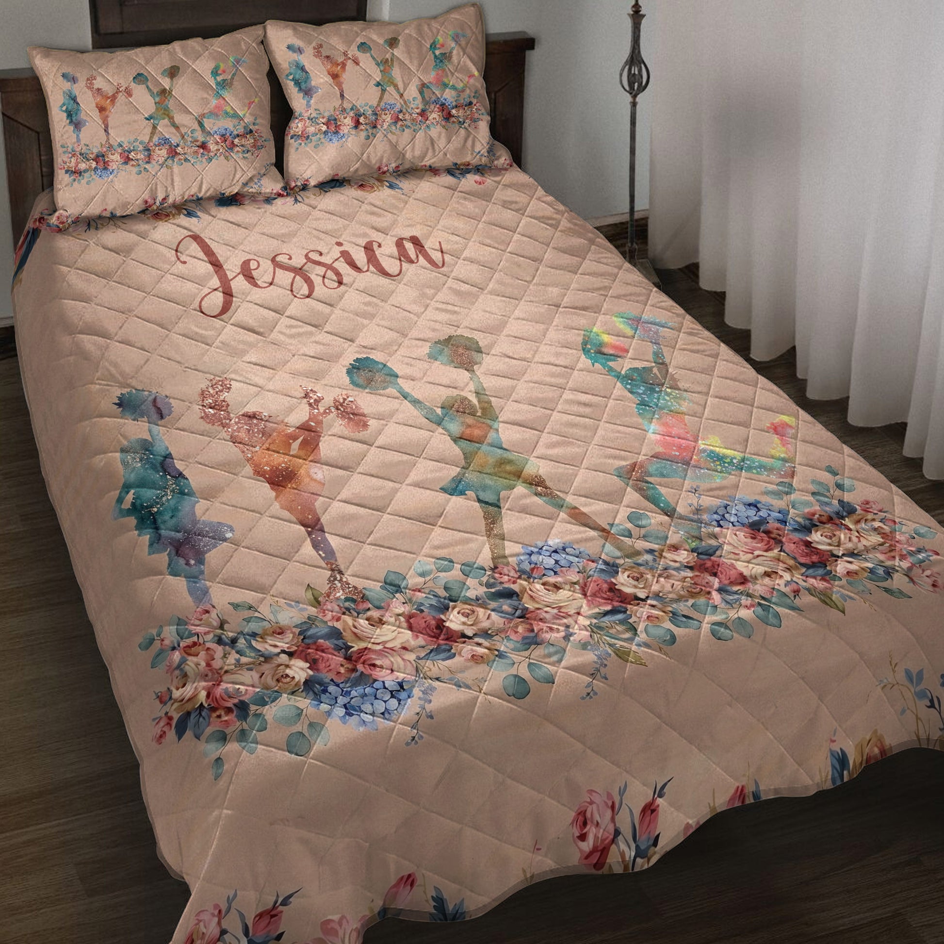 Cheerleading quilt blanket displayed on a bed with colorful cheerleader silhouettes and floral artwork
