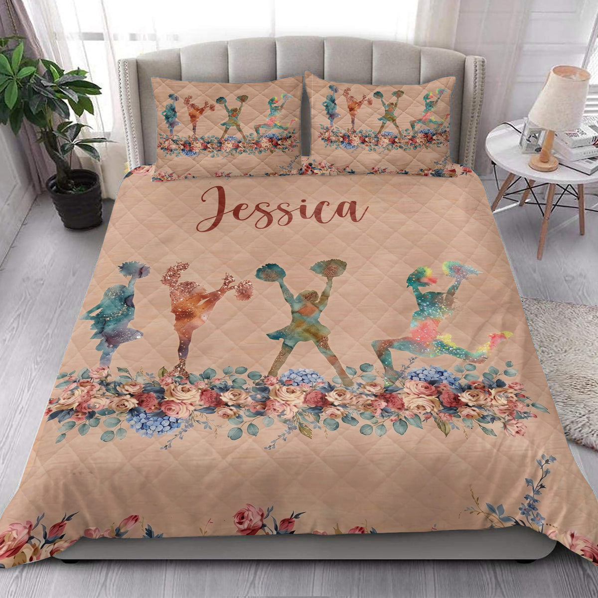 Cheerleading quilt bedding styled in a bright bedroom with colorful cheerleader silhouettes and flowers