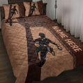 Lineman quilt blanket displayed on a bed with power lineworker artwork in brown and black